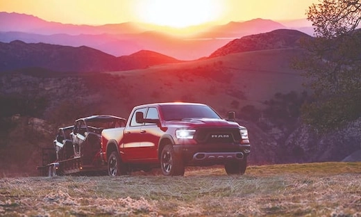 2019 Red Ram 1500 Towing a Trailer at Sunset