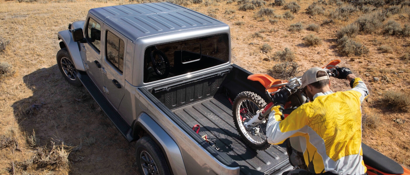 2020 Silver Jeep Gladiator Loading a Dirt Bike