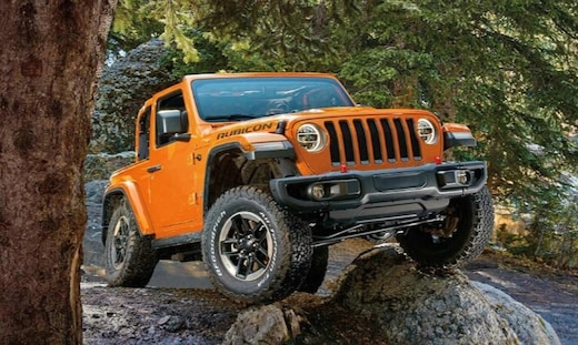 2019 Orange 2-Door Jeep Wrangler Rubicon Parked on a Rock